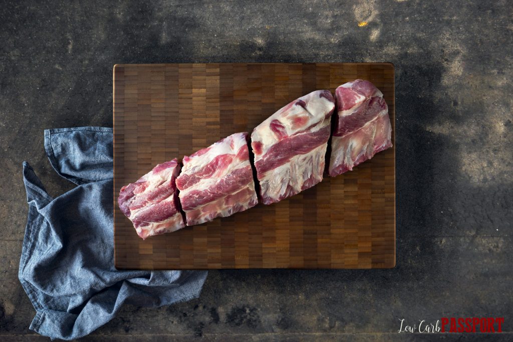 pork back ribs cut into 4 pieces on cutting board